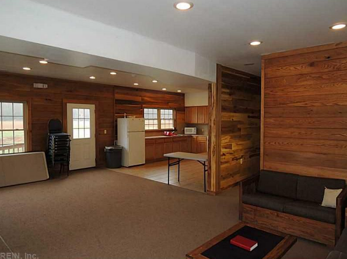 A room with wood paneling and a fireplace.