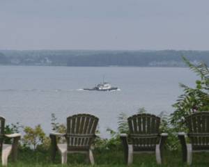 Two lawn chairs facing a body of water