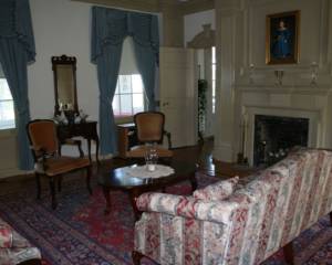 A living room with a couch, chair and fireplace.