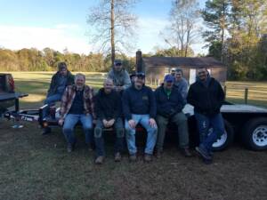 A group of people sitting on top of a bench.