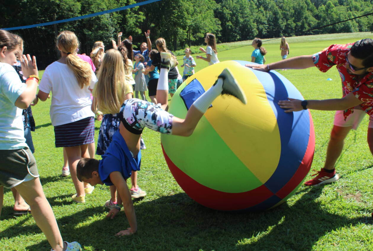 A group of people playing with an inflatable ball.