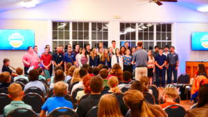 A group of people standing in front of a crowd.