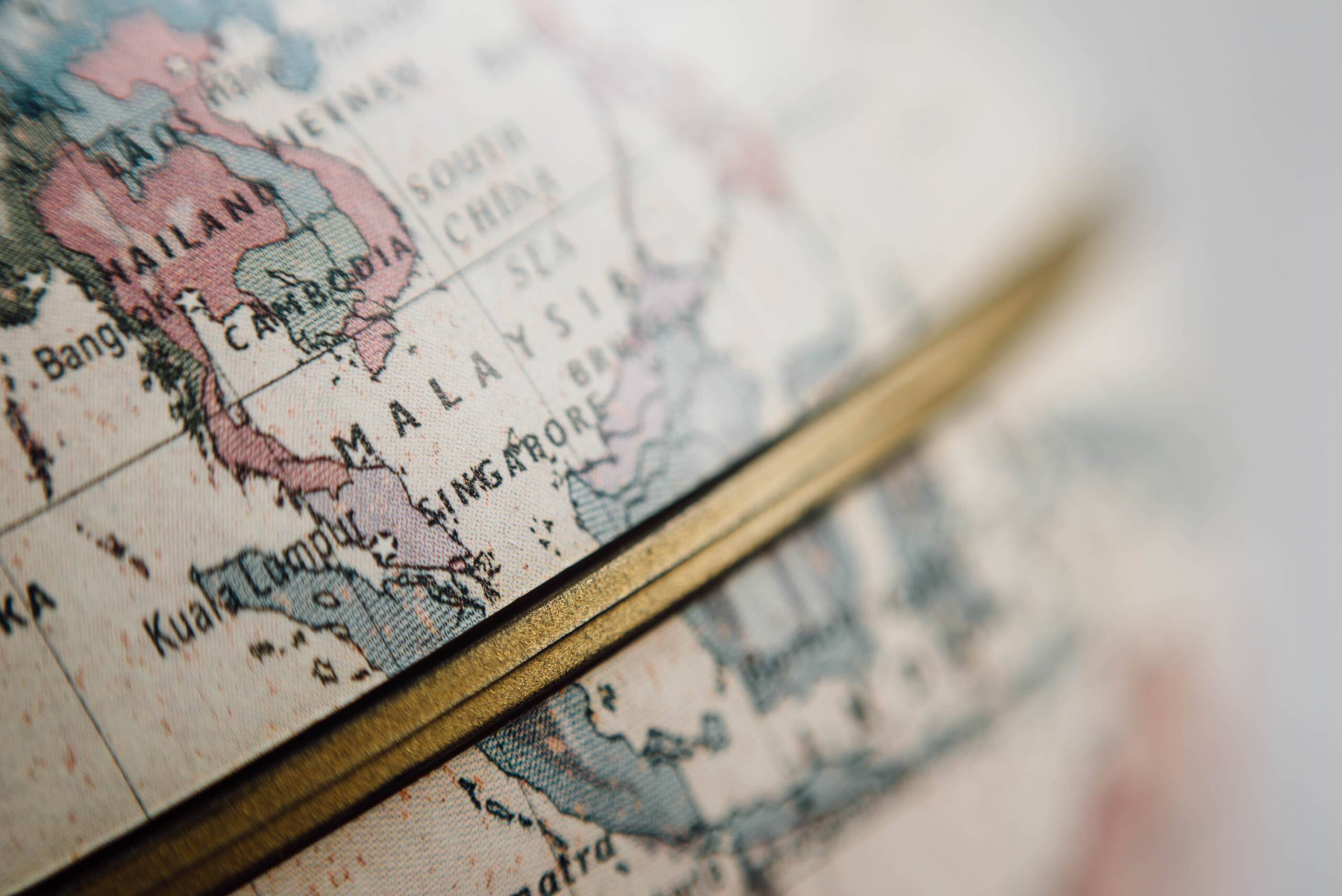 A close up of the world map with a gold edge
