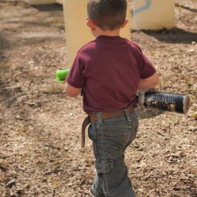 A young boy holding a baseball bat in his hand.